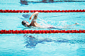 Swimmer racing in pool