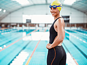 Portrait of smiling swimmer at poolside