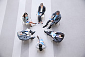 Business people sitting in circle