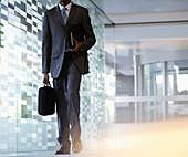 Businessman carrying briefcase in lobby