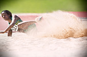 Long jumper landing in sand