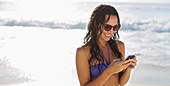 Smiling woman text messaging