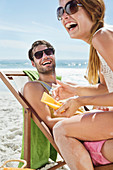 Happy couple with sunscreen at beach
