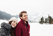 Happy couple in snowy field