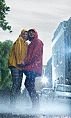 Happy couple in raincoats