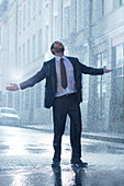 Businessman in rainy street