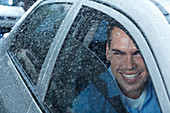 Portrait of smiling man in car