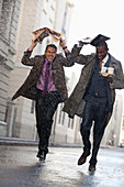 Businessmen with coffee in rainy street