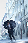 Businessman under umbrella