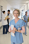 Smiling nurse in hospital corridor