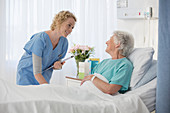 Nurse and aging patient talking room