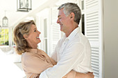 Senior couple hugging on patio