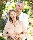 Smiling senior couple hugging outdoors