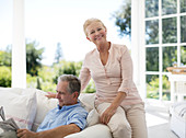 Senior couple relaxing on sofa on porch