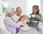 Senior women toasting coffee cups