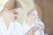 Woman using digital tablet at spa