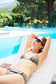 Woman relaxing at poolside