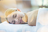 Woman laying on massage table in spa