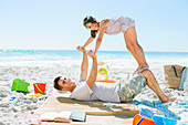 Father and daughter playing on beach