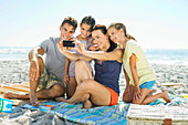 Family taking self-portrait at beach