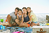 Smiling family on blanket at beach