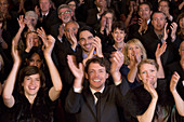 Happy audience clapping in theatre