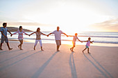 Family holding hands on beach