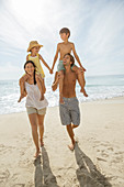 Parents carrying children on shoulders