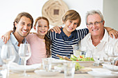 Family smiling together at table