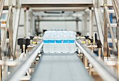 Water bottles on conveyor belt in factory
