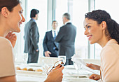 Businesswomen talking in restaurant