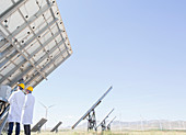 Scientists examining solar panel
