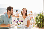 Couple enjoying coffee on balcony