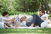 Multi-generation men relaxing on blanket