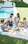 Family enjoying picnic in backyard