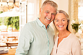 Older couple smiling indoors