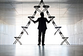 Businessman arranging office chairs