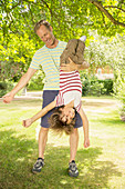 Father holding son upside-down