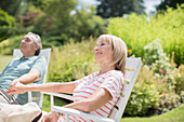 Senior couple relaxing in backyard