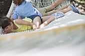 Children relaxing in hammock outdoors