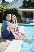 Couple relaxing at poolside