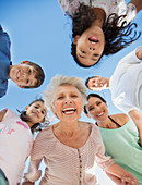 Multi-generation family smiling in huddle