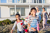 Family on beach path outside house