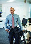 Businessman with bicycle in office