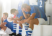 Disappointed soccer players sitting