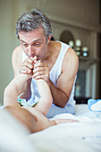 Father kissing baby's feet