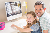 Father and daughter using computer