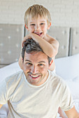 Father and son hugging on bed