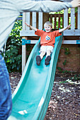 Father catching son on slide