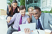 Business people cheering outdoors